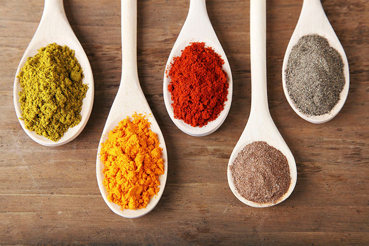 Various spice powders in spoons