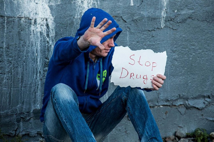 Boy with stop drug banner