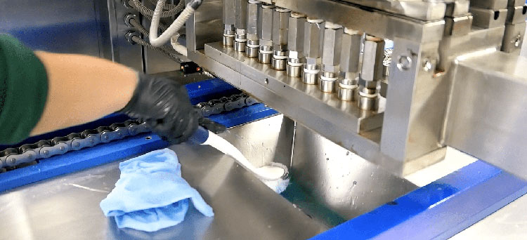 Operator cleaning a gummy making machine